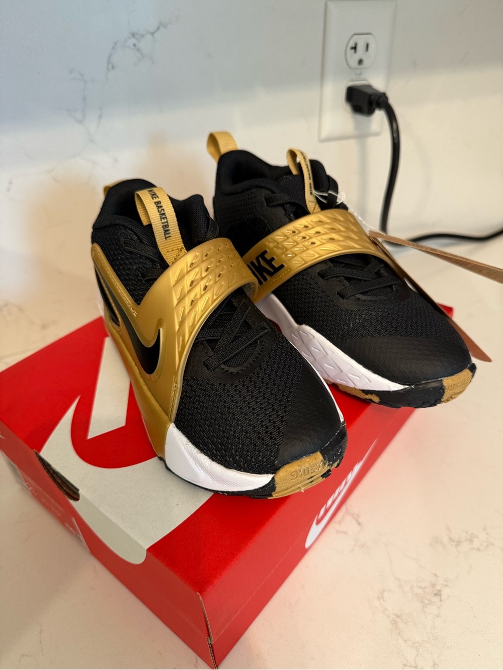 Nike Team Hustle Kids Black and Gold Strap Athletic Sneakers